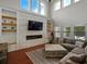 Spacious living room showcasing a fireplace with stone accent wall and bright windows at 7927 Hampton Lake Dr, Tampa, FL 33647