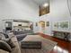 Spacious living room with hardwood floors, tall ceilings, a large sectional sofa, and stylish decor at 7927 Hampton Lake Dr, Tampa, FL 33647