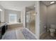 Modern bathroom with double sinks, a soaking tub, a glass-enclosed shower, and neutral tones at 7927 Hampton Lake Dr, Tampa, FL 33647
