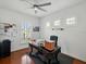 Well-lit home office space with hardwood floors, a ceiling fan, and plantation shutters at 7927 Hampton Lake Dr, Tampa, FL 33647