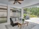 Covered patio with seating area and view of backyard and outdoor grill at 7927 Hampton Lake Dr, Tampa, FL 33647