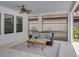 Cozy covered patio features comfortable seating, ceiling fan, and neutral decor at 7927 Hampton Lake Dr, Tampa, FL 33647
