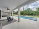 Inviting backyard pool and spa with ample seating and lush landscaping, a perfect outdoor oasis at 7927 Hampton Lake Dr, Tampa, FL 33647