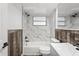 Bathroom featuring a tub, marble tile, wood accent, white toilet, and gray vanity at 8733 Goshen Ln, Port Richey, FL 34668
