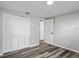 Bedroom with closet, wide plank flooring, neutral color palette, and baseboards at 8733 Goshen Ln, Port Richey, FL 34668