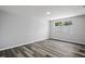 This bedroom has wood-look flooring and a window for natural light at 8733 Goshen Ln, Port Richey, FL 34668