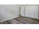 Bedroom with closet, wide plank flooring, neutral color palette, and baseboards at 8733 Goshen Ln, Port Richey, FL 34668