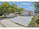 Single Gathering home with attached garage, long driveway, and trees at 8733 Goshen Ln, Port Richey, FL 34668