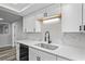 Contemporary kitchen design with stainless steel sink, sleek white cabinets, and modern backsplash at 8733 Goshen Ln, Port Richey, FL 34668