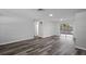 Spacious living room featuring modern gray flooring, freshly painted walls, and sliding glass doors to the backyard at 8733 Goshen Ln, Port Richey, FL 34668