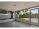 Enclosed patio with large tree and view of fenced yard at 8733 Goshen Ln, Port Richey, FL 34668