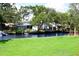 Lush backyard with canal access, showcasing waterfront living and mature trees for added privacy at 8817 Audrey Ln, Tampa, FL 33615