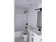 A clean bathroom features a tub, toilet, vanity, black fixtures, and modern finishes at 8817 Audrey Ln, Tampa, FL 33615