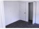 An empty bedroom features gray flooring, white walls, and a closet at 8817 Audrey Ln, Tampa, FL 33615
