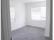 A bedroom features tile flooring and two windows at 8817 Audrey Ln, Tampa, FL 33615