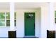 Inviting entryway featuring a green front door with a window and white pillars in a well-lit space at 8817 Audrey Ln, Tampa, FL 33615