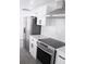 Modern kitchen featuring stainless steel appliances, white cabinets, and sleek countertops for a clean look at 8817 Audrey Ln, Tampa, FL 33615