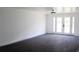 Bright, spacious living room featuring modern flooring and white French doors leading to the outdoors at 8817 Audrey Ln, Tampa, FL 33615