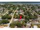 Aerial view of a charming home nestled in a lush neighborhood with lake views at 9653 Golden Grove St, Seminole, FL 33772