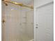 Modern tiled shower with glass doors and gold fixtures complements the bathroom's design at 9653 Golden Grove St, Seminole, FL 33772