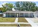 Charming one-story home featuring a lovely front porch and well-maintained landscaping, creating inviting curb appeal at 9653 Golden Grove St, Seminole, FL 33772