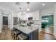 Elegant kitchen with white cabinets, granite countertops, stainless appliances, an island with seating, and hardwood floors at 9653 Golden Grove St, Seminole, FL 33772