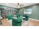 Cozy living room featuring comfortable green armchairs and a stylish display of liquor bottles at 9653 Golden Grove St, Seminole, FL 33772