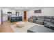 Bright living area with a kitchen, hardwood floors, stylish seating, and an open layout for relaxation and entertainment at 9653 Golden Grove St, Seminole, FL 33772