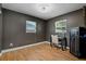 Home office space featuring a desk, chair, safe and two windows at 9653 Golden Grove St, Seminole, FL 33772