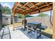 Outdoor kitchen area equipped with a grill, smoker, and lighting, ideal for culinary enthusiasts at 9653 Golden Grove St, Seminole, FL 33772