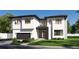 Striking modern two-story home with a clean white facade, black trim, and well-manicured landscaping at 2867 Sunstream Ln, Clearwater, FL 33759