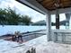 Under-construction outdoor kitchen area by the pool with metal framing and modern patio pavers at 2867 Sunstream Ln, Clearwater, FL 33759