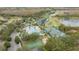 An aerial view of a community pool, tennis courts, and golf course at 10525 Lucaya Dr, Tampa, FL 33647