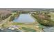 Scenic aerial view of a lush golf course surrounding a tranquil lake on a sunny day at 10525 Lucaya Dr, Tampa, FL 33647