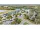 An aerial view of the clubhouse with a parking lot, tennis courts, and a pool at 10525 Lucaya Dr, Tampa, FL 33647