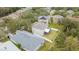 Rear aerial view of property showing yard with a screened in porch at 10525 Lucaya Dr, Tampa, FL 33647