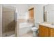 Bathroom with a glass-enclosed shower, soaking tub, and neutral tile at 10525 Lucaya Dr, Tampa, FL 33647