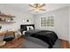 Bedroom with modern decor, featuring hardwood floors, desk, and a queen bed at 10525 Lucaya Dr, Tampa, FL 33647