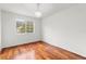 A bedroom with natural light showcases stunning hardwood floors and a stylish chandelier fixture at 10525 Lucaya Dr, Tampa, FL 33647