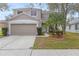Charming two-story home boasts a well-manicured lawn, a two-car garage, and complemented by lush tropical landscaping at 10525 Lucaya Dr, Tampa, FL 33647