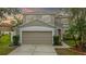 Charming two-story home with a well-manicured lawn and a neutral color scheme at 10525 Lucaya Dr, Tampa, FL 33647
