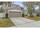 Charming two-story home boasts a well-manicured lawn, complemented by lush tropical landscaping and a two-car garage at 10525 Lucaya Dr, Tampa, FL 33647