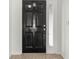 Stylish black front door with glass panel, complemented by tiled flooring, offers a glimpse of the home's interior at 10525 Lucaya Dr, Tampa, FL 33647