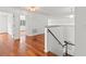 Upstairs hallway featuring hardwood floors and white walls, with access to various rooms at 10525 Lucaya Dr, Tampa, FL 33647