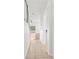 Bright hallway with stairs, arched doorway, and tiled floors, offering a glimpse into the home's open layout at 10525 Lucaya Dr, Tampa, FL 33647