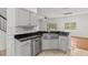Bright kitchen with stainless steel sink, granite countertops, and white cabinets at 10525 Lucaya Dr, Tampa, FL 33647