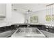 Close up of kitchen sink with granite countertops and stainless steel faucet at 10525 Lucaya Dr, Tampa, FL 33647