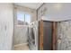 Laundry room features updated washer/dryer and decorative wallpaper at 10525 Lucaya Dr, Tampa, FL 33647