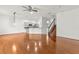 Open-concept living area with hardwood floors, white walls, and view into the kitchen and staircase at 10525 Lucaya Dr, Tampa, FL 33647