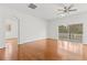 Bright living room with hardwood floors, ceiling fan, and sliding glass doors leading to the outdoors at 10525 Lucaya Dr, Tampa, FL 33647